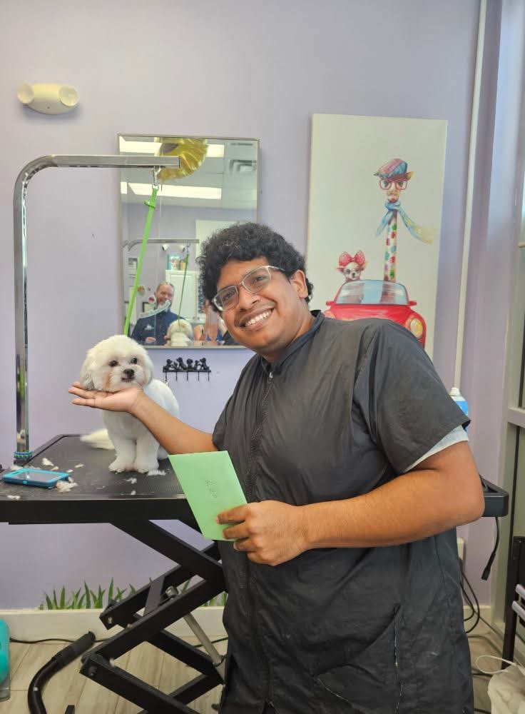 smiling groomer with dog
